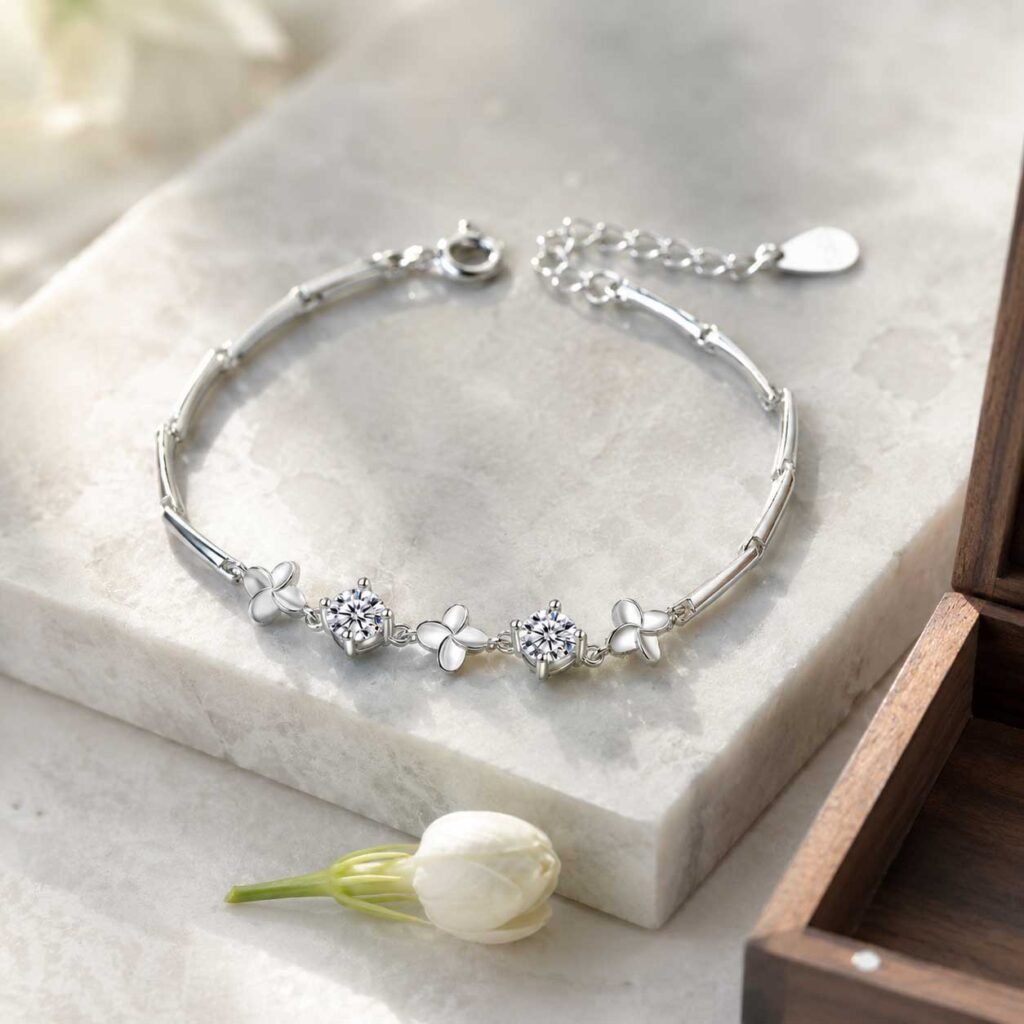 Close-up of a premium classic good luck bracelet made of polished refined copper links with detailed jasmine flower charms, 24h sound-bath calibrated at 528Hz, displayed elegantly inside the signature white Luxe Abundance Box.
