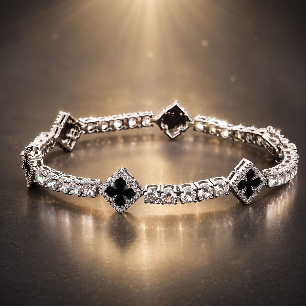 Close-up of a black clover zirconia bracelet with deep dark stones in polished gold-tone frames, presented in the white Luxe Abundance Box.