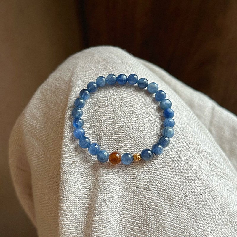 Handcrafted natural blue kyanite bracelet with distinctive bladed stone beads, presented in the white Luxe Abundance Box.