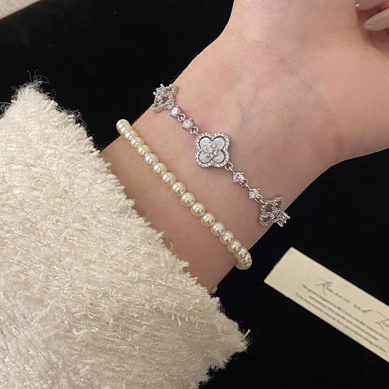 Ritualized white clover bracelet in mother of pearl style, 24h sound-bath cleansed for 2026 emotional balance, presented in a signature Luxe Abundance Box.